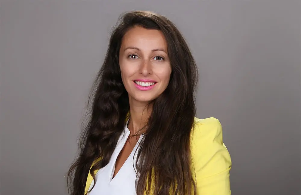 Country roads to coastal vibes: 1000MTG hits right note with two 2026 conference reveals 3 Headshot of 1000MTG CEO Nicola Veltman in yellow blazer against plain background.