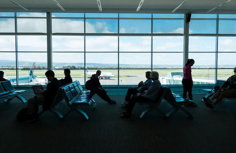 This surprising Australian capital city leads rise in corporate travel spend, Flight Centre division reveals 1 Passengers at gate at Adelaide Airport. Image: aiyoshi597/Shutterstock