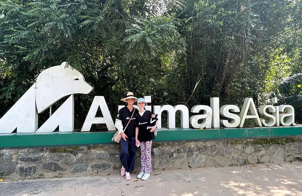 Movers + Shakers: Adventure World increases ANZ leadership with 2 new strategic hires 1 Adventure World Head of Product Anna Burgdorf with her daughter in front of Animals Asia sign in Vietnam.
