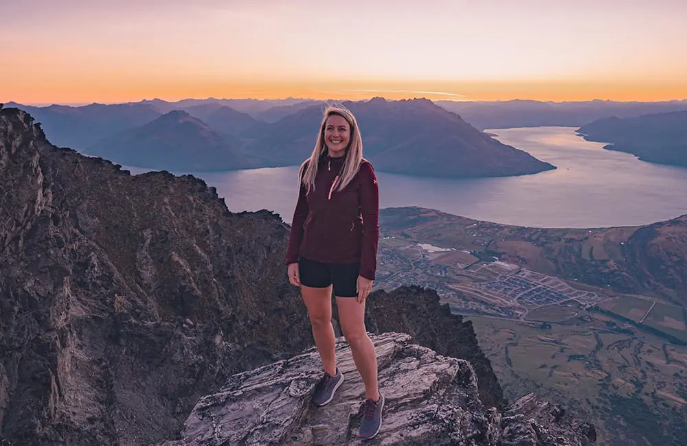 Movers + Shakers: Adventure World increases ANZ leadership with 2 new strategic hires 2 Adventure World New Zealand National Sales Manager Emily Fernandes on top of a mountain.