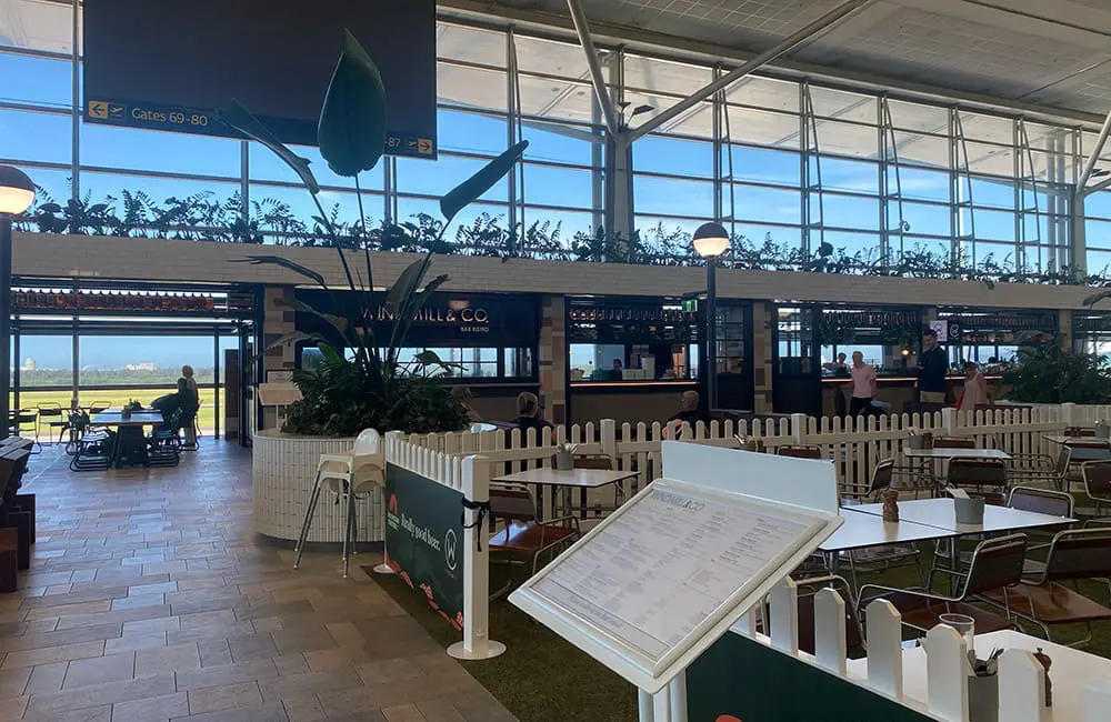 Flight Test: Singapore Airlines – Brisbane to Brussels on a mixed-class ticket 1 Departures gate and restaurants at Brisbane International Airport. Image: Cassie Tannenberg