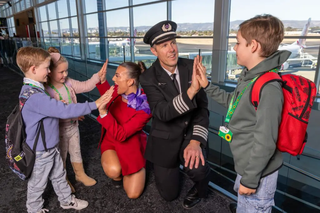 Barrier breaker: Virgin Australia, Adelaide Airport’s new program makes air travel more accessible 2 Virgin flight crew Flight Attendant Jade Broadhead and Pilot Peter Monu with Frankie 7, Lorelai 5 and Spencer 8 taking part in the Try before you Fly program at Adelaide Airport. Picture by Kelly Barnes