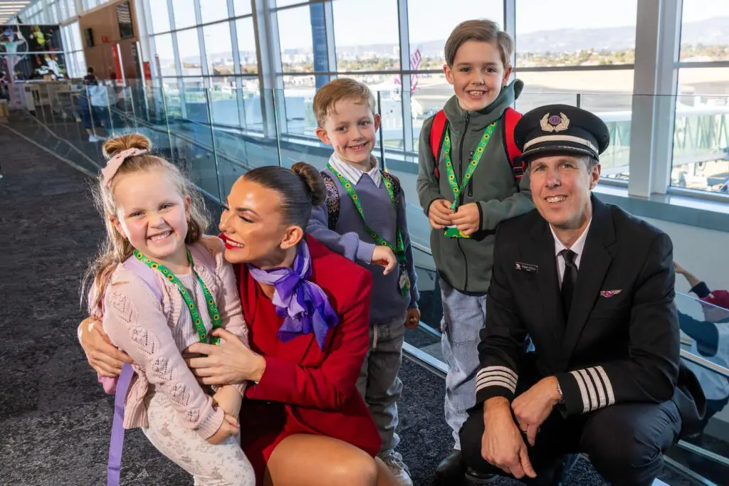 May 31, 2025: Virgin flight crew Flight Attendant Jade Broadhead and Pilot Peter Monu with L to R, Lorelai 5, Frankie 7,  and Spencer 8 taking part in the Try before you Fly program at Adelaide Airport. Picture: Kelly Barnes