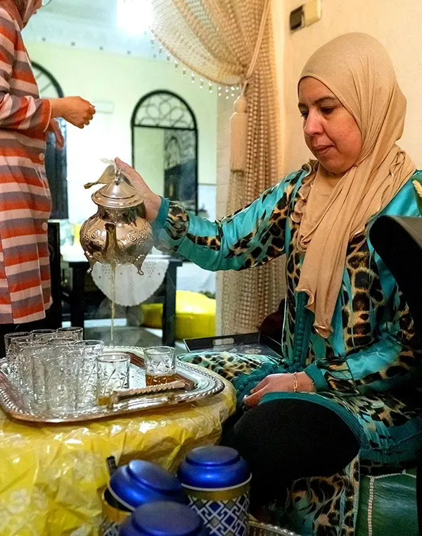 The average Aussie spends how much on a 2-week overseas holiday? And where’s it going? 3 Local woman pouring mint tea on Explore Worldwide's Discover Morocco tour.