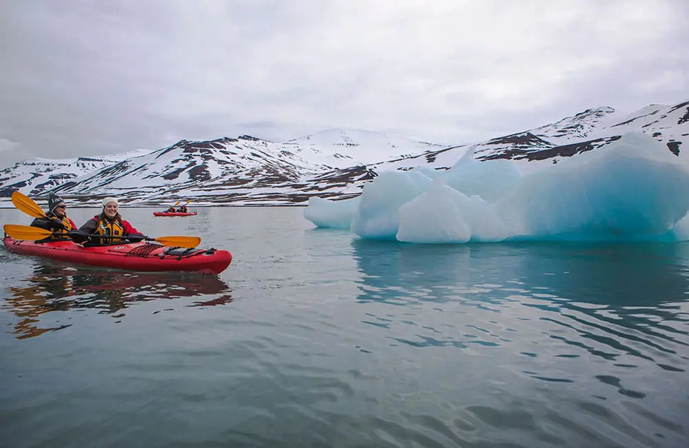 G Adventures makes a polar power move with double the ships to the Arctic & Antarctic by July 2025 3 Kayaking around icebergs in Svalbard, Norway on an Arctic expedition trip. Image: G Adventures