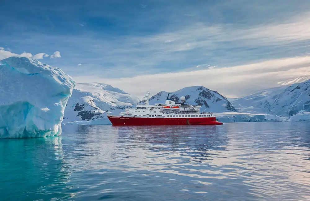 G Adventures makes a polar power move with double the ships to the Arctic & Antarctic by July 2025 4 The new Expedition small-ship vessel in Antarctica surrounded by icebergs. Image: G Adventures