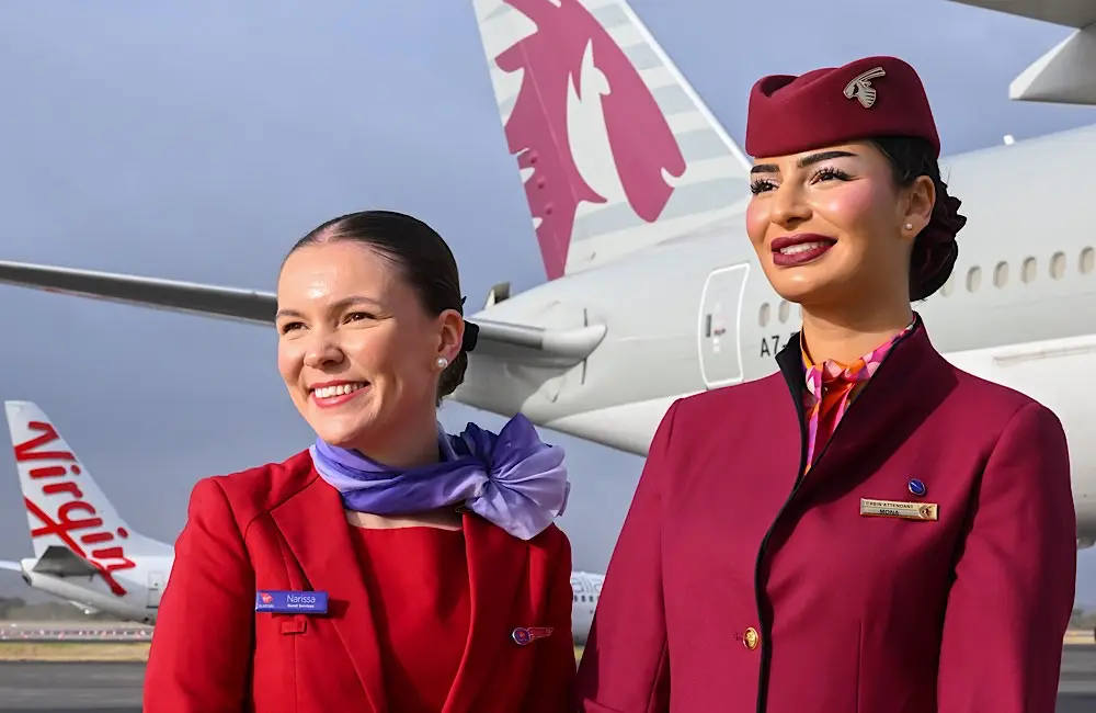 Virgin's new Brisbane–Doha flight unlocks 170 destinations: Here’s what’s onboard 3 Side by side on the tarmac: Virgin Australia and Qatar Airways crew celebrate the first Brisbane–Doha service, backed by aircraft from both airlines.