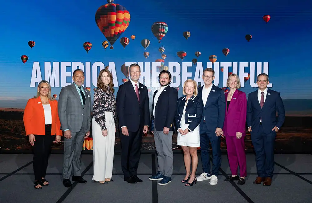 America the Beautiful: Brand USA's bold new global campaign counters funding uncertainty 2 Brand USA executive team with President & CEO Fred Dixon on stage at IPW25. Image: Brand USA