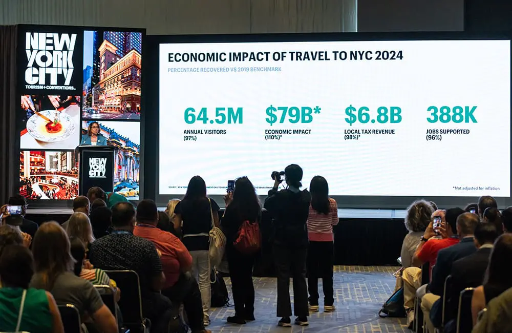NYC targets luxury travellers for strategic tourism recovery as it hits 97% of 2019 levels 1 International media take photos of the presentation of NYC's 2024 tourism figures. Image: Natasha Moustache for NYC Tourism + Conventions