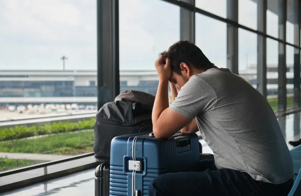 Karryon Top 10 stories of the week: Catch up on our most-wanted: Jun 13 8 Stressed male traveller with luggage at Narita Airport holds his head in his hands.