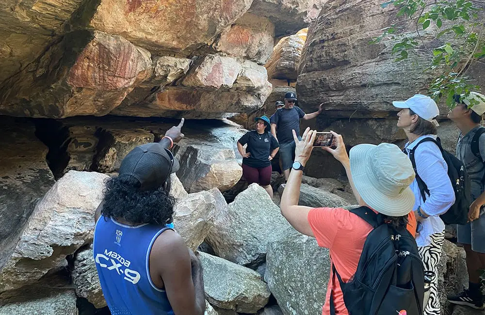 NT rolls out first-ever Aboriginal Tourism Product Awareness Program famil 6 The ATPAP famil group view Injalak Hill rock art with Kakadu Cultural Tours guide John. Image: Tourism NT