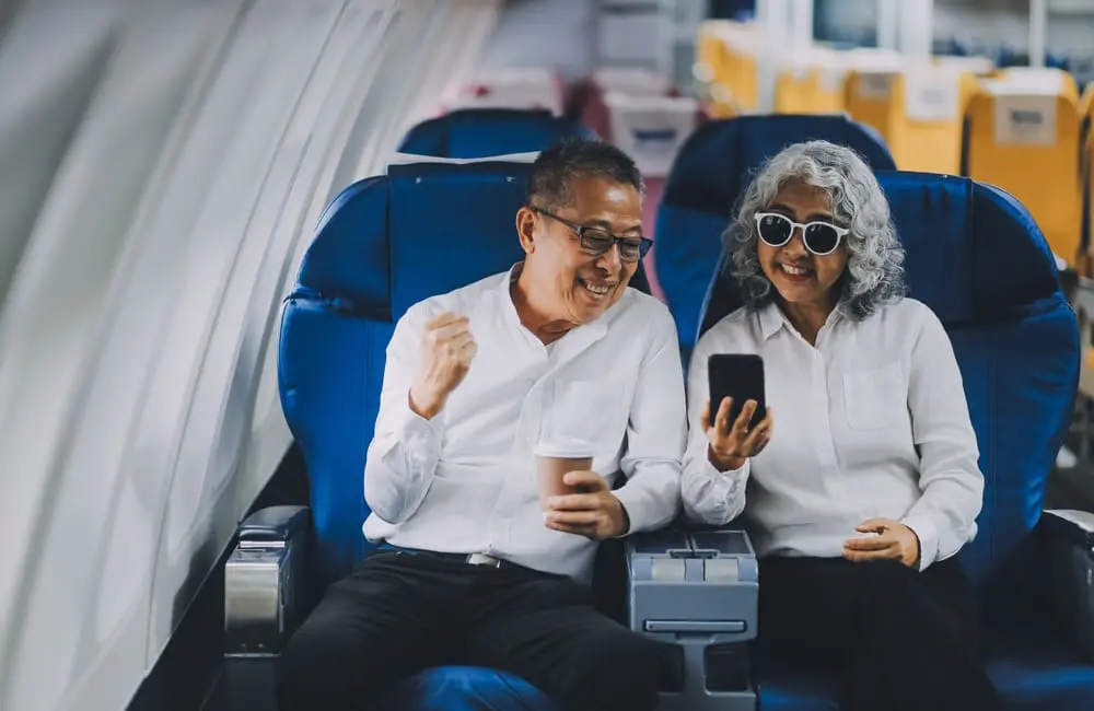 Most Aussies say this is the best time to fly overseas – and it’s not what you’d expect 3 Older plane passenger couple – preferred times for flying overseas. Image: Shutterstock