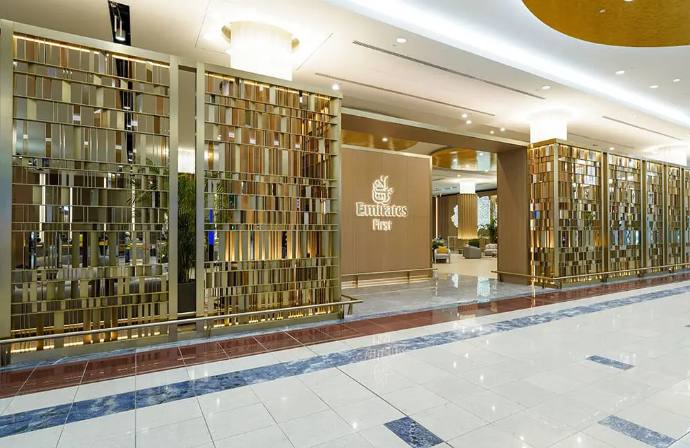 The gold gateway entrance at Emirates First check-in area at Dubai International Airport.