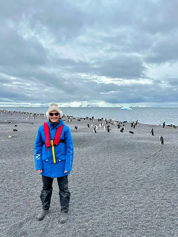 Movers + Shakers: Eclipse Travel elevates Hilary Dubyk as General Manager 2 Eclipse Travel GM Hilary Dubyk in Antarctica with penguins on beach.