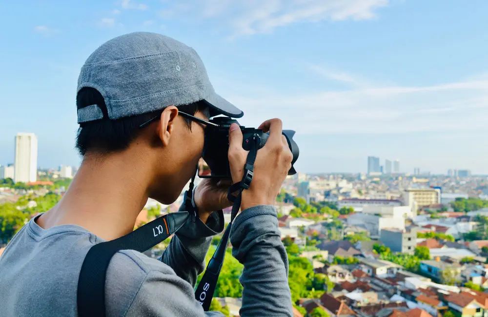 Karryon Top 10 stories of the week: Catch up on our most-wanted: Jul 18 1 Male tourist with DSLR camera pointed at cityscape in Surabaya, Indonesia. Karryon Top 10 Stories of the Week