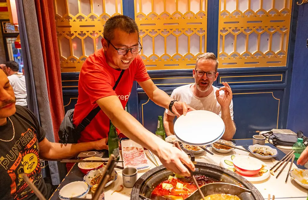 Intrepid Travel expands trip range after Aussie travellers stan this lesser-known Asian region 1 Intrepid Travel CEO James Thornton (right) tries spicy Sichuan hotpot in Chengdu, China. Image: Intrepid Travel