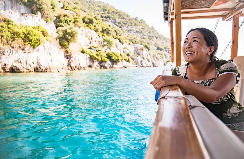 Agents, start flipping: Intrepid Travel hides golden tickets in latest brochure 3 Female traveller on gulet in Kas, Turkiye on an Intrepid Travel trip.