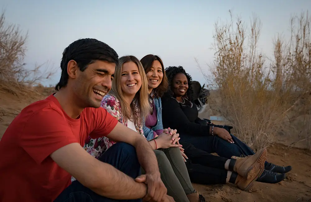 Movers + Shakers: Intrepid Travel adds Alexa Theofanou as new Head of Marketing for Australia and NZ 2 Intrepid Travel Trip Leader with group sitting in Kyzylkum desert yurt camp in Uzbekistan.