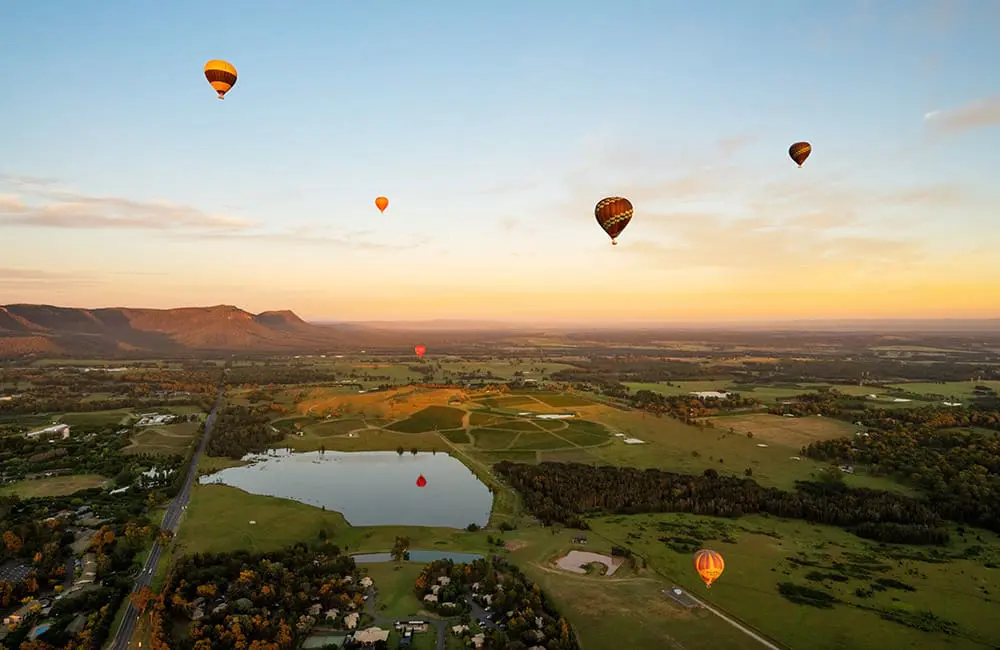 Beach-bound Aussies: Family travel surge forecast for Thailand & Bali this summer 3 Landscape image of hot-air balloons over Hunter Valley, NSW. Image: Luxury Escapes