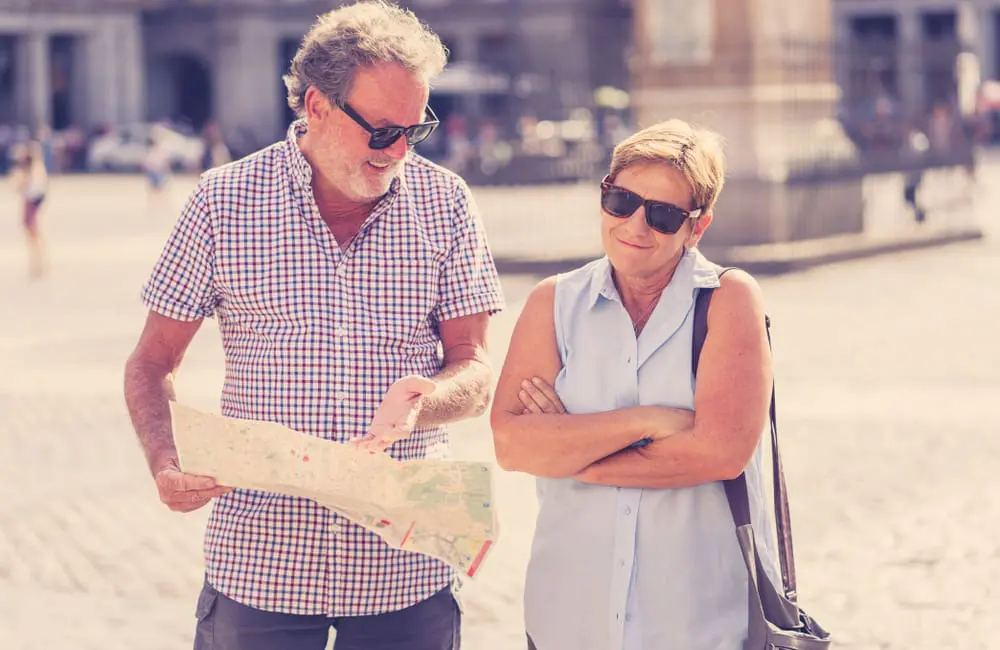 Romance vs reality: Holidays spark clashes for 40% of Aussie couples 1 Senior tourist couple lost with map in city – arguments on holidays. Image: Shutterstock