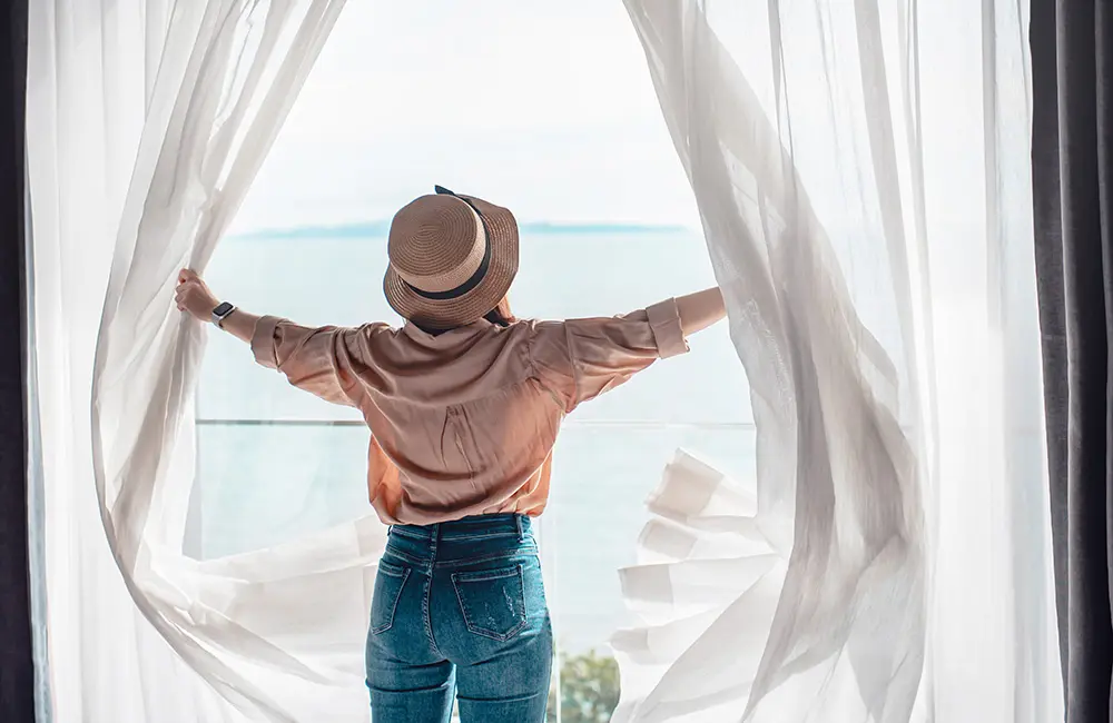 Karryon Top 10 stories of the week: Catch up on our most-wanted: Jul 25 7 Woman with back to camera opens curtains to an oceanfront view at resort.