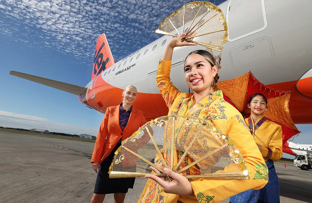 Karryon Top 10 stories of the week: Catch up on our most-wanted: Jul 18 6 Two women in traditional Filipino dress with Jetstar flight attendant at Brisbane Airport on tarmac with aircraft.