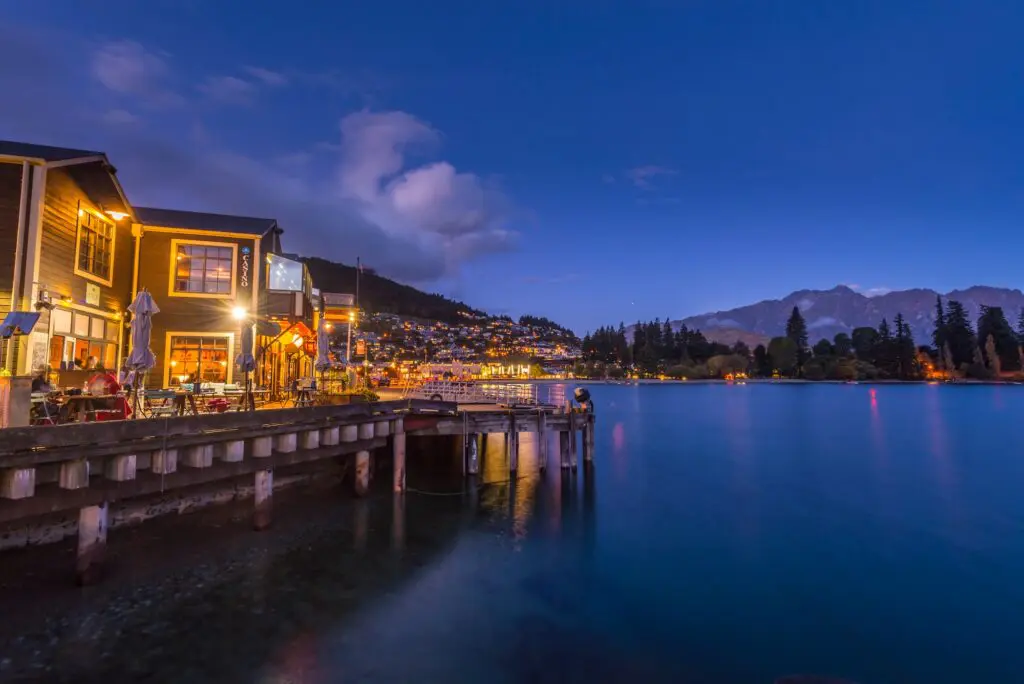 Destination Queenstown CEO Mat Woods interview: What Aussies love most about the resort town 1 Queenstown, New Zealand - April 17 2017: Bustling lakeside businesses in Queenstown in the evening