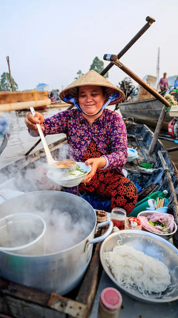 Exclusive: Flight Centre Global MD unpacks the future of its new FC-branded guided tour range 4 Woman at street food stall in Vietnam. Flight Centre Tours.