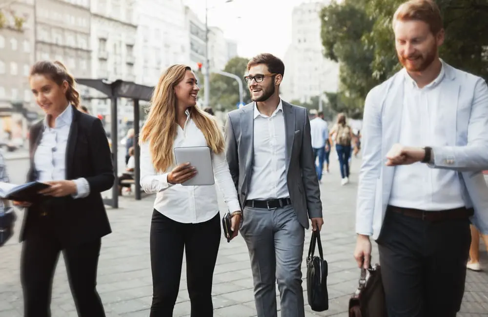 Group of young business travellers walking in a city. Image: Shutterstock