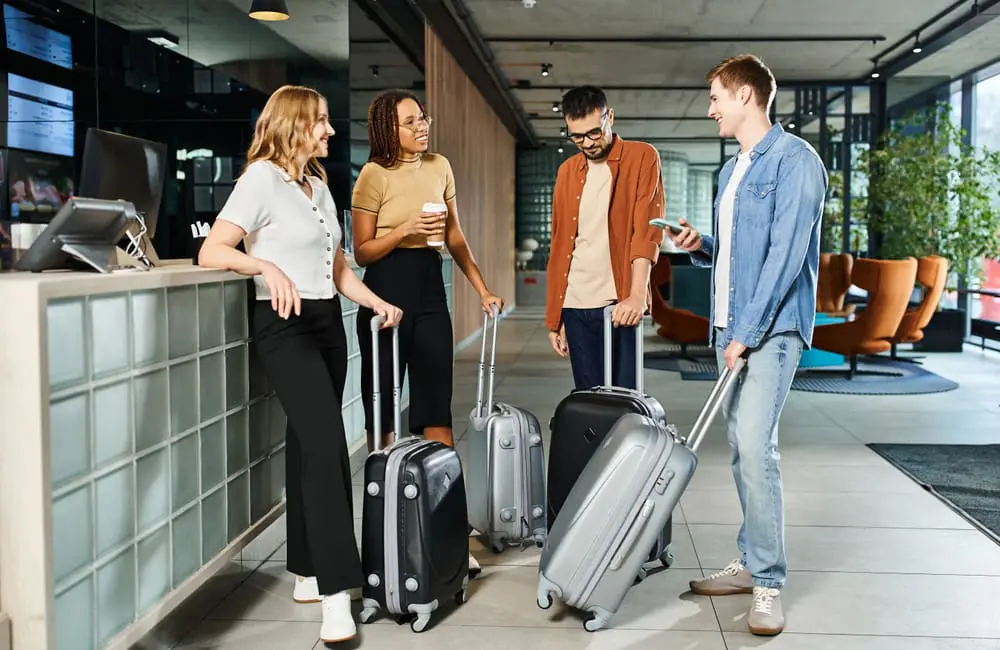 Why travel is key to keeping Australia’s under-45 workforce happy & engaged 2 Group of young Gen Z and Millennial business travellers in hotel check-in.