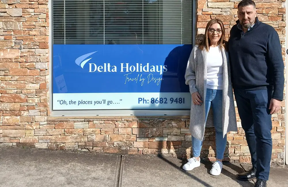 Delta Holidays joins Helloworld Travel’s growing Associate family in Melbourne 1 Delta Holidays Owners Eve Costopoulos and Dion Gerasimidis outside the store with sign.
