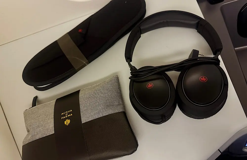 Signature Class Flight Review: Air Canada AC33 Vancouver to Sydney and the long‑haul dilemma of sleep or story 3 Acqua di Parma amenity kit, noise-cancelling headphones and slippers, provided to Signature Class passengers for comfort on the 15-hour Vancouver–Sydney flight.