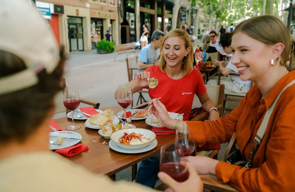 Intrepid Travel’s TV series returns for second season: What destination is on show? 3 Intrepid Travel group dining at outside bar in Barcelona, Spain for Intrepid Adventures TV series.