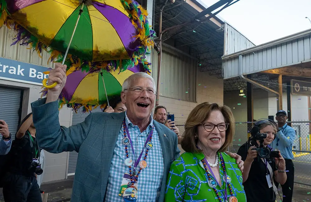 Carnival on track! Amtrak restores Mardi Gras Service between New Orleans & Mobile 4 Couple with Mardi Gras colours for Amtrak Mardi Gras Service resumption. Image: Larry Everage Jr