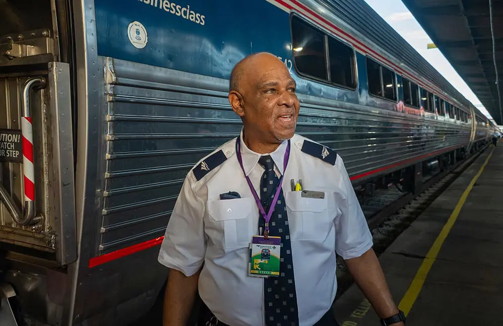 Amtrak Mardi Gras Service train with staff member. Image: Larry Everage Jr