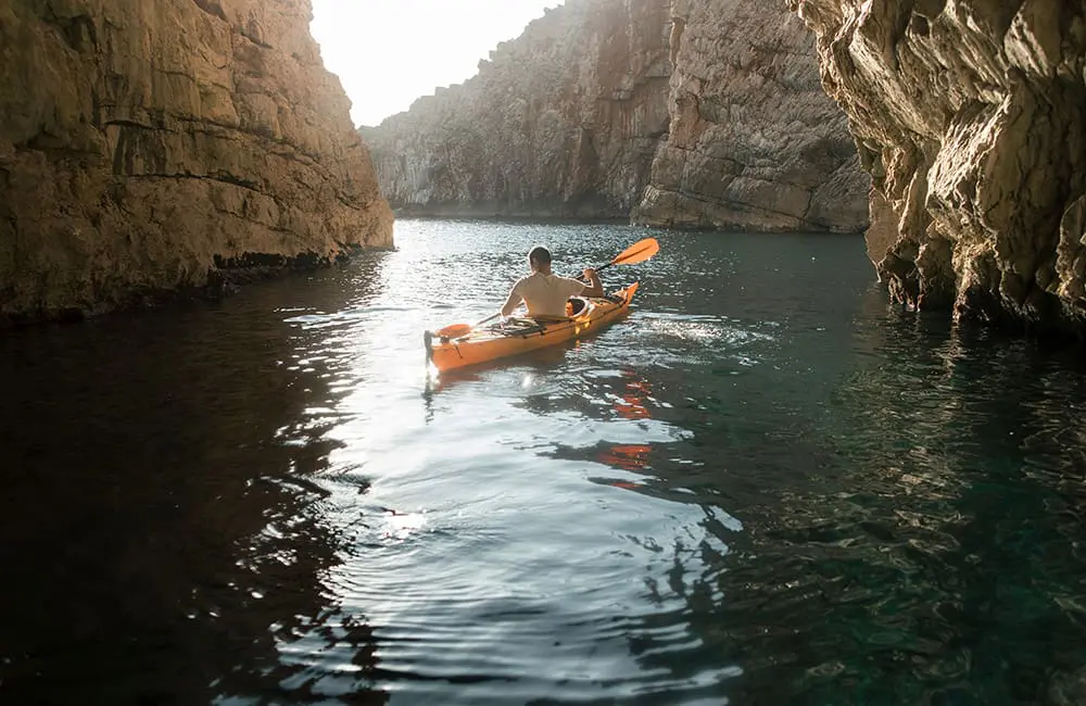 Tauck launches new luxury brand – its first in a decade – and it’s geared for a specific demographic 4 Man kayaking between rocks – Roam by Tauck