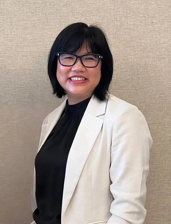 Headshot of Tweet World Travel Founder & CEO Thuy Carroll.