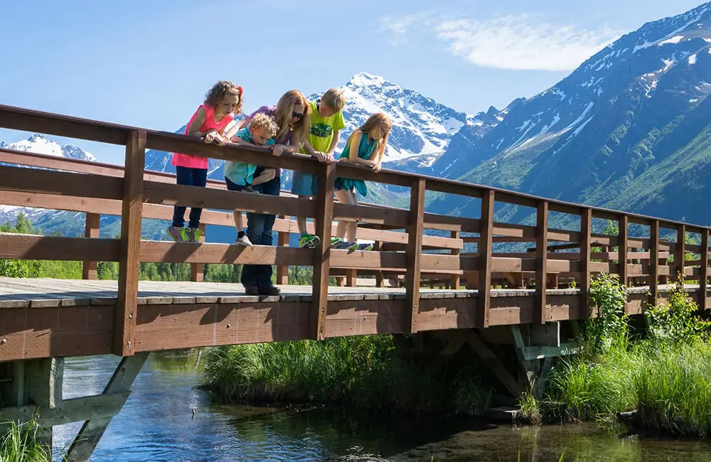 Mythbusting with Visit Anchorage: 7 things that are real (& unreal) about Southcentral Alaska 4 Family time at Eagle River Nature Center Bridge near Anchorage, Alaska. Image: JodyO.Photos