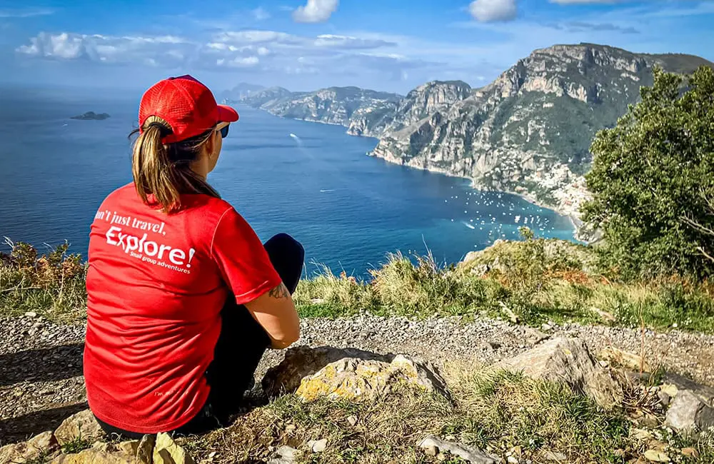 7 in 10 Aussies shrug off peak Europe travel for shoulder seasons in 2025 and beyond: Here’s why 8 Explore Worldwide guide with branded t-shirt on Amalfi Coast Walking trip.