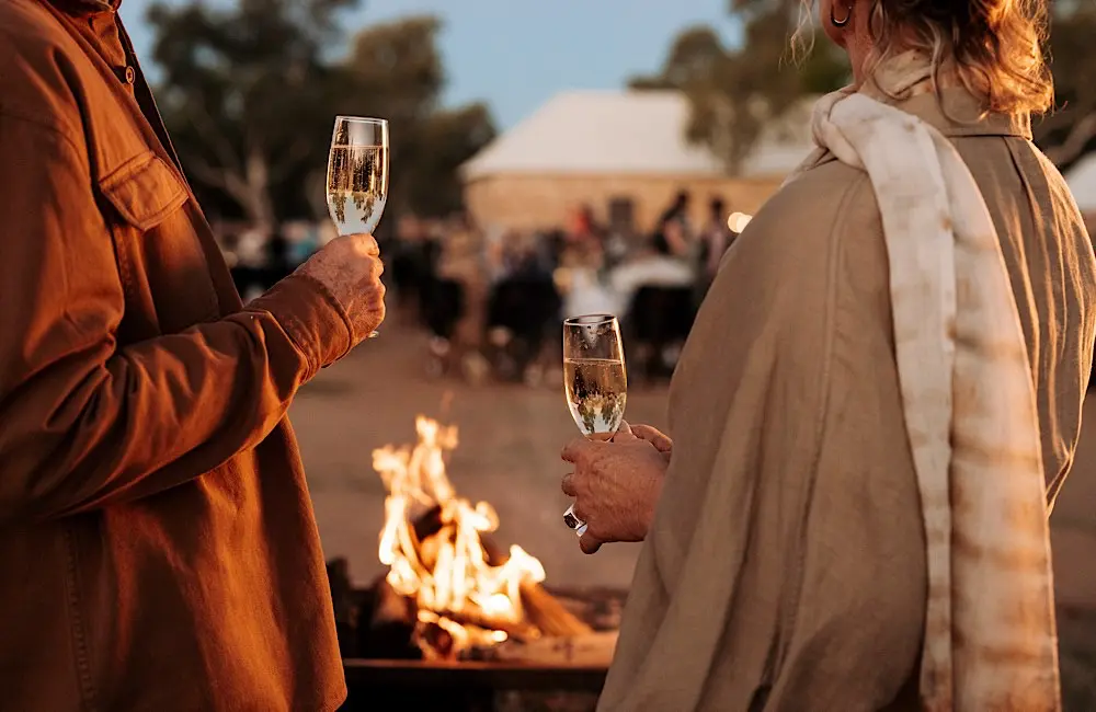 Beyonder belief: Journey Beyond’s $20K mega famil is back! 2 Champagne in hand at Alice Springs Telegraph Station – celebrating the famil in true Journey Beyond style.