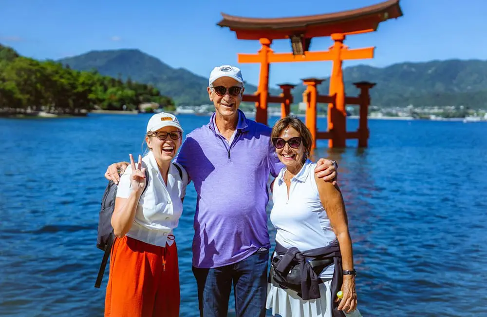 InsideJapan launches largest-ever small-group tour program for 2026 as interest hits record highs 2 InsideJapan tour leader and clients in Miyajima.