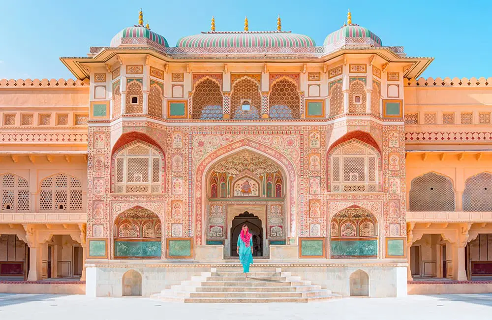 Fly free or save big: Wendy Wu Tours unveils biggest-ever flight sale with savings of up to $2K 2 Woman walking out of Jaipur building. Image: Wendy Wu Tours