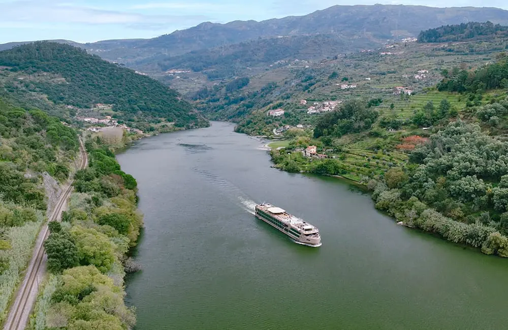 Aerial image of APT Estrela river ship on Douro River in Portugal. APT Travel Group