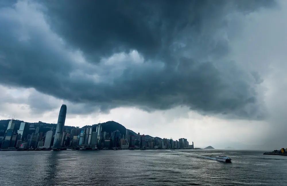 700 flights grounded: Hong Kong braces for travel chaos as Super Typhoon Ragasa nears 3 Hong Kong downtown with dark clouds in storm.