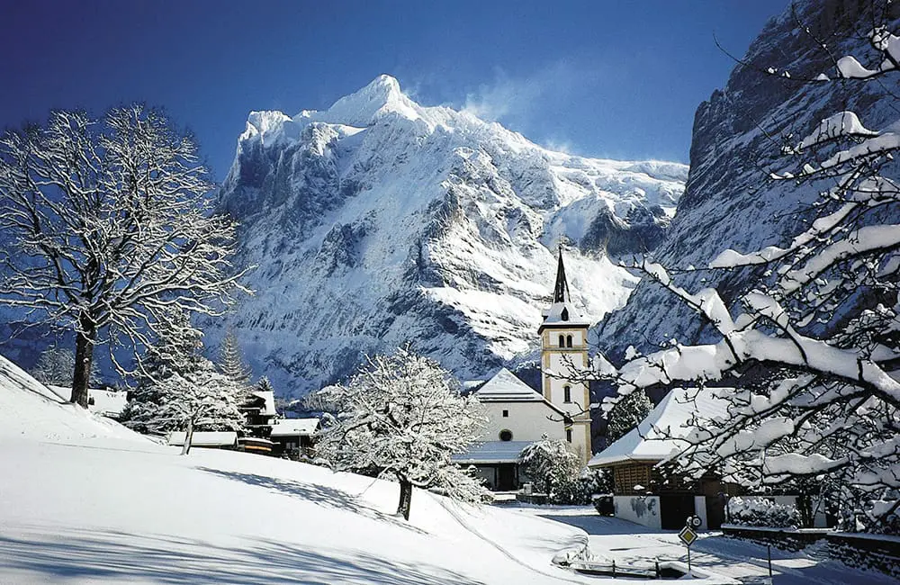 Grindelwald Church in Grindelwald, Switzerland in winter. Albatross Tours Festive 2026 
