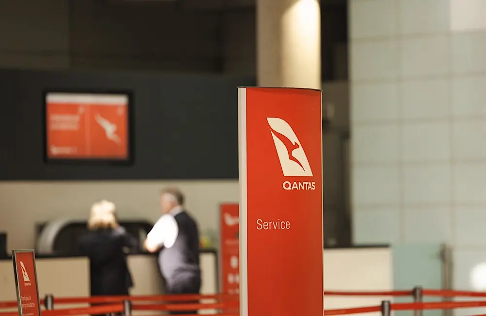 Travellers check in at Qantas counters. Agents are advised to reassure clients that no financial or passport data was compromised in the recent cyber incident.