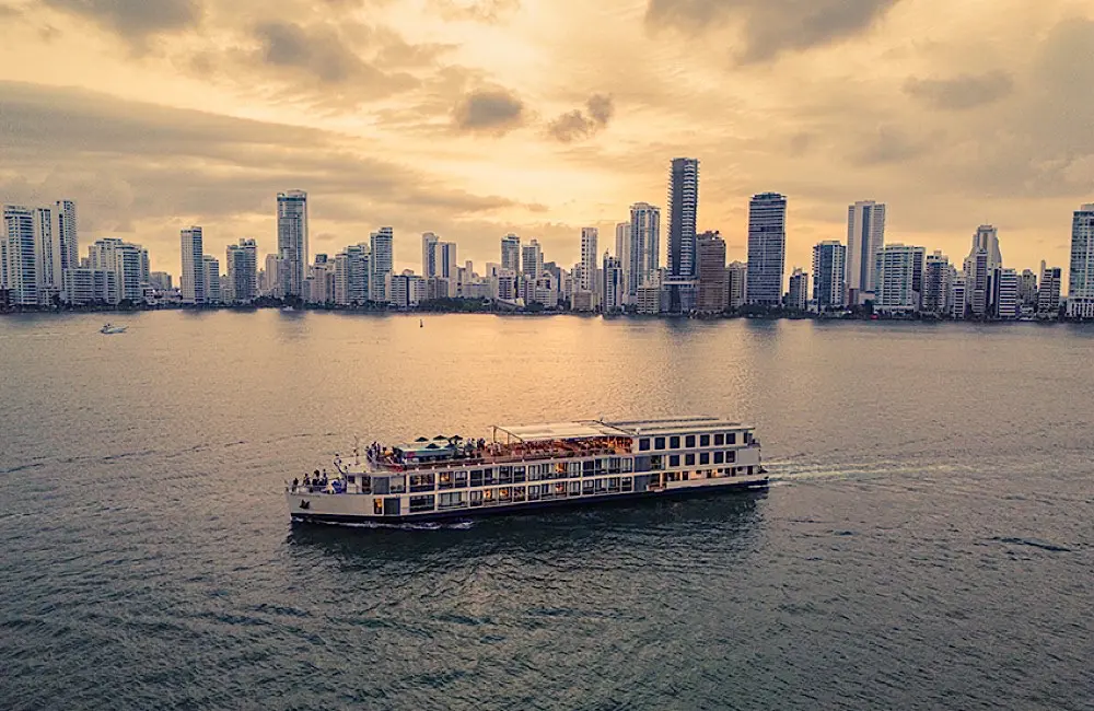 An AmaWaterways river ship sails past Cartagena’s skyline, reflecting the company’s expanding global footprint across Europe, Asia, Africa and South America.