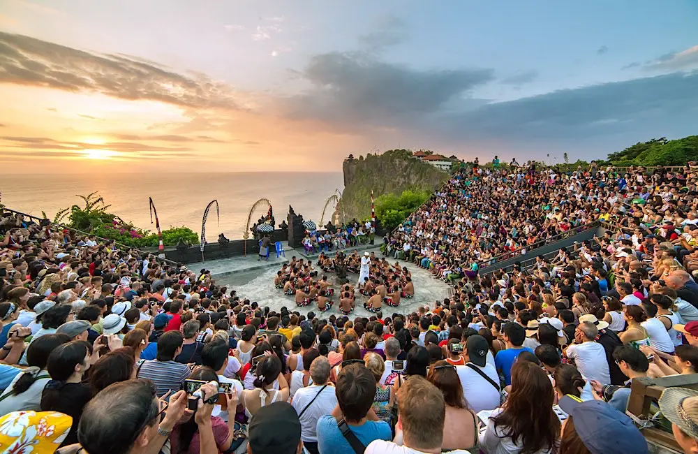 Double-digit drop: Aussie US travel falls further; these 3 nations surge 1 Bali, Indonesia - September 19: Tourists watch traditional Balinese Kecak Dance at Uluwatu Temple on Bali, Indonesia. Image: Mazur Travel / Shutterstock.com