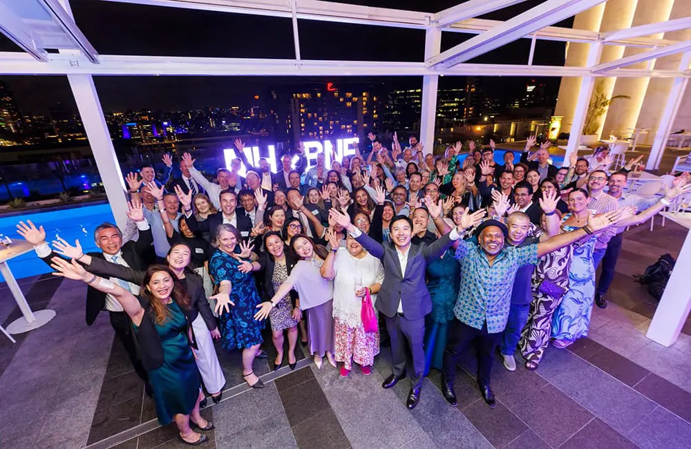 Relaunched flights & new connections: Brisbane Airport celebrates Malaysia Airlines' imminent return 3 Group of people with arms up at BNE x MH event at Lina Rooftop in Brisbane.