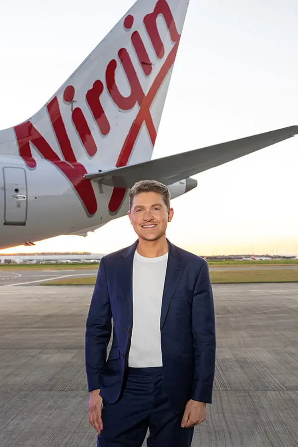 Movers + Shakers: Matthew Ongarello returns to Virgin Australia as Head of PR & Brand 3 Virgin Australia Group Head of PR & Brand Matthew Ongarello on tarmac with aircraft tail.